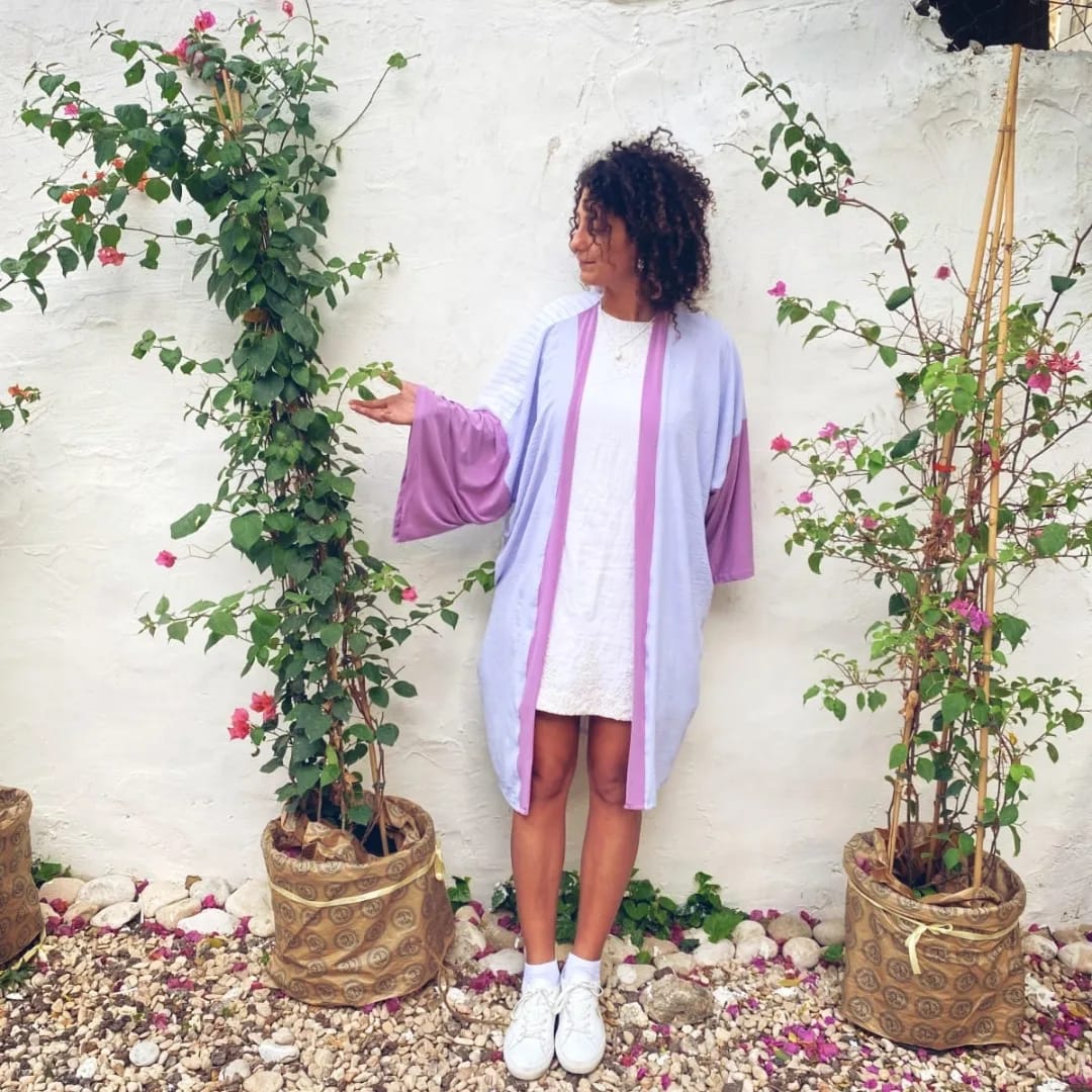 Lightweight kimono in lavender silk with magenta trim, worn in a garden